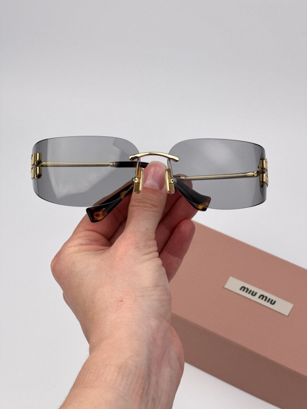 Miu Miu Women’s Sunglasses – Gold Grey Rectangle Rimless (MUA51S 5AK50K)